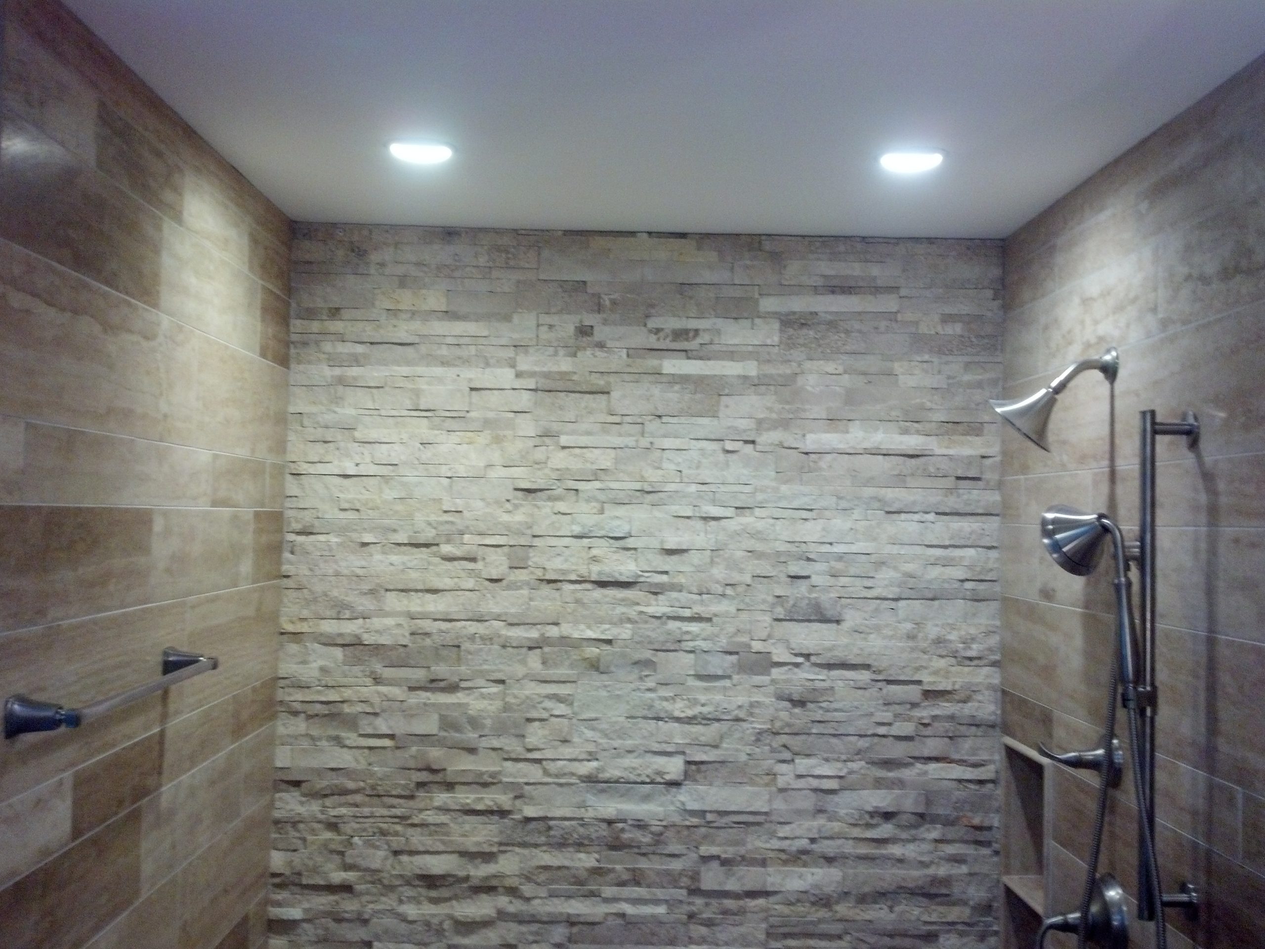 Close up of a large walk-in tiled shower. 