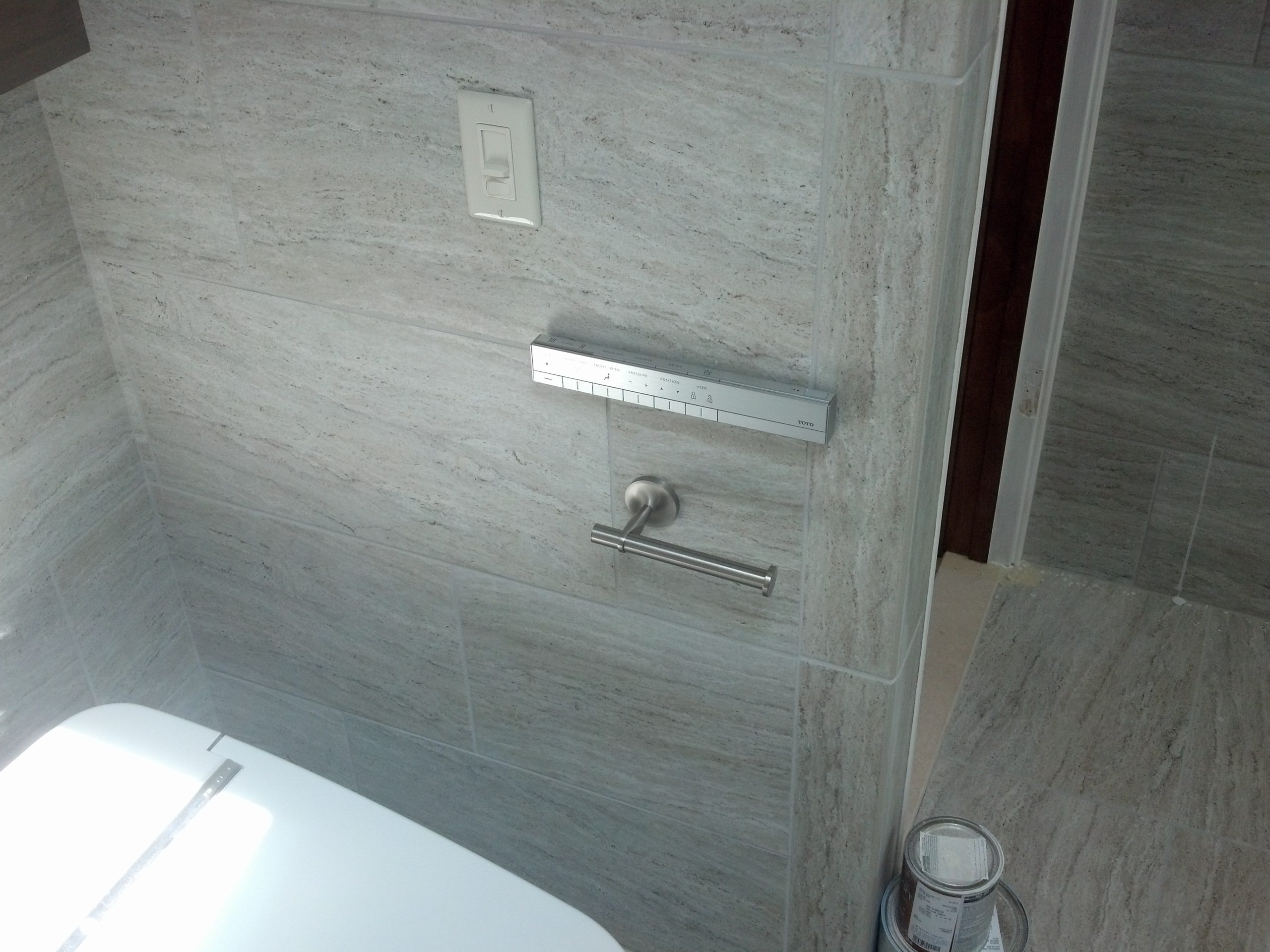 Close up of modern bathroom wall in light grey that was recently renovated. 