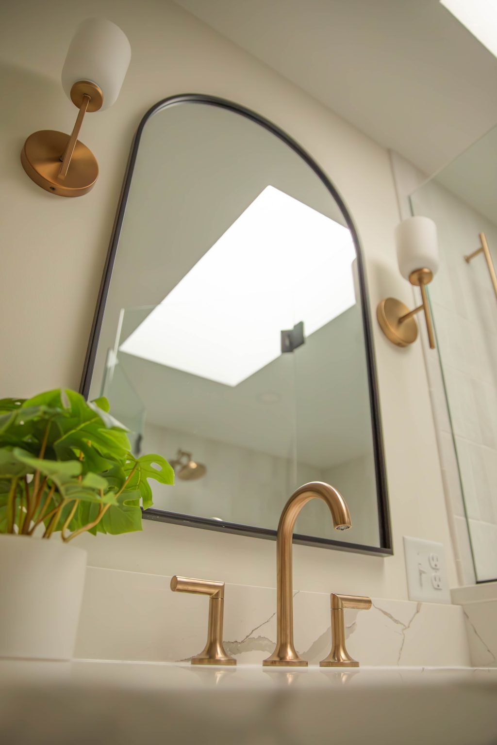 Black framed arch mirror installed by bathroom remodeler in Sylvania