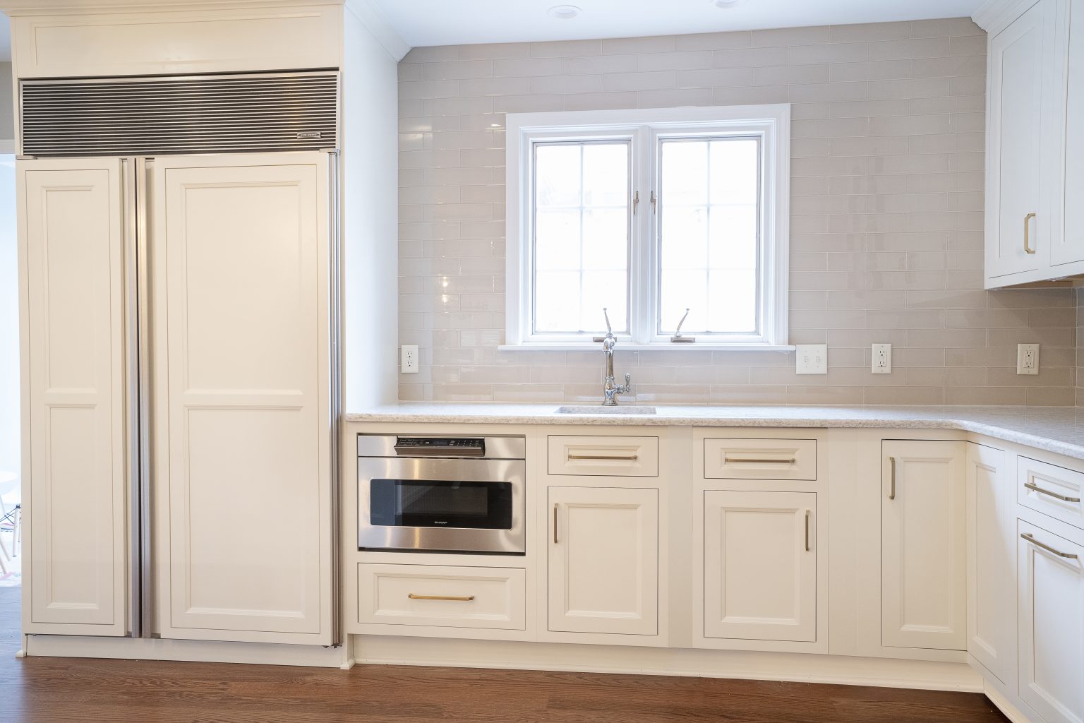 White cabinets with built in appliances and ample countertop space installed by a kitchen remodeler in Ottawa Hills