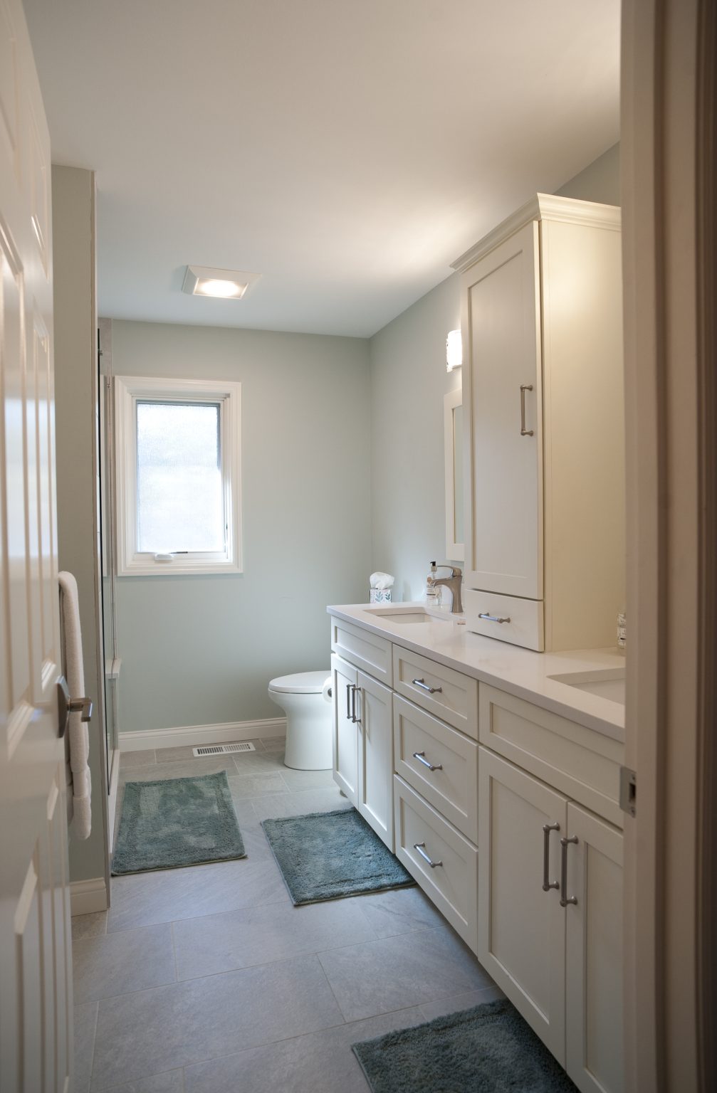 Modern bathroom with dual vanity and custom medicine cabinet installed by Perrysburg bathroom remodeler