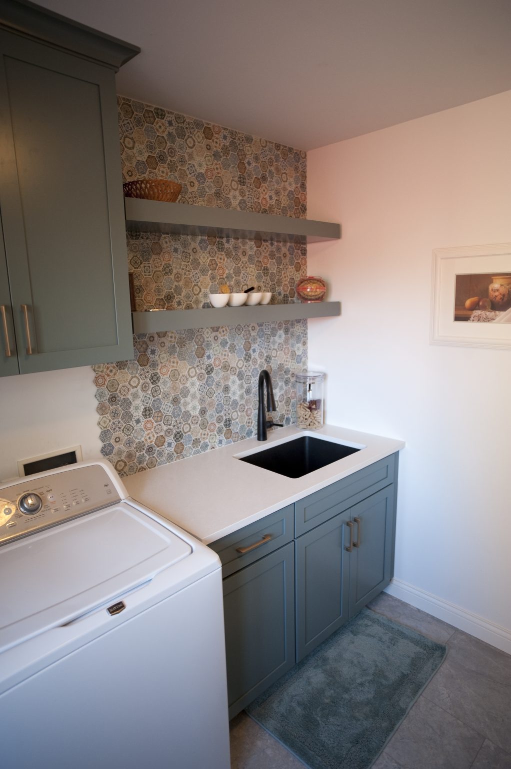 Modern laundry room with utility sink and custom painted shelves installed by home remodeler in Perrysburg