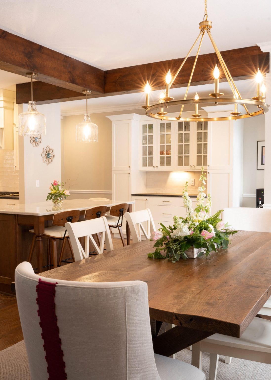 Modern dining table with chairs and elegant chandelier installed by kitchen remodeler in Old Orchard